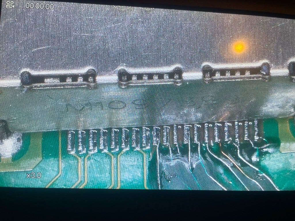 Microscope view of precision solder joints on a connector