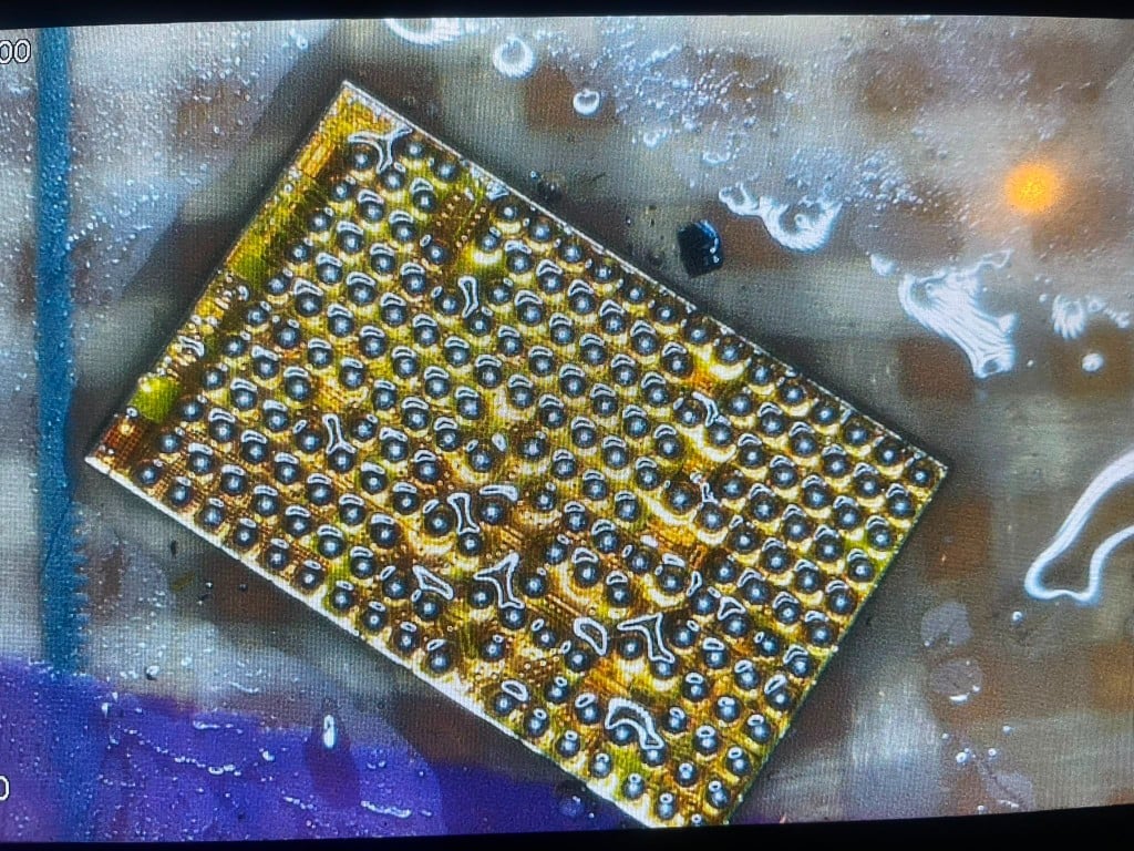 BGA chip underside showing solder ball grid under the microscope