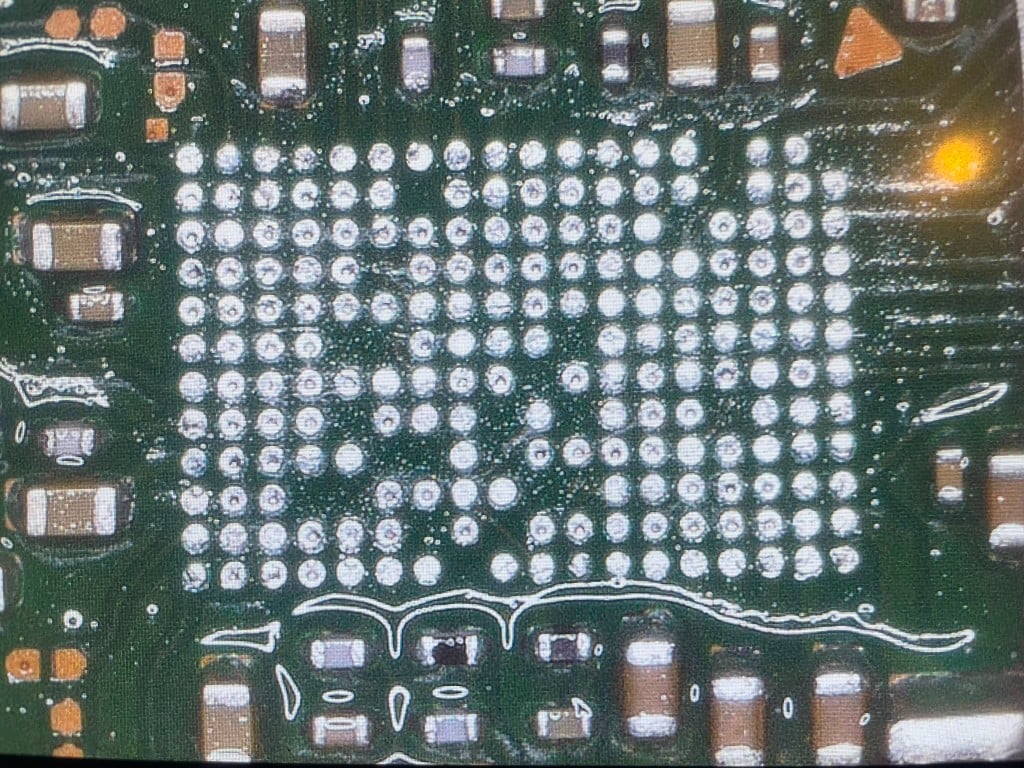 Microscope view of BGA pad grid on a circuit board