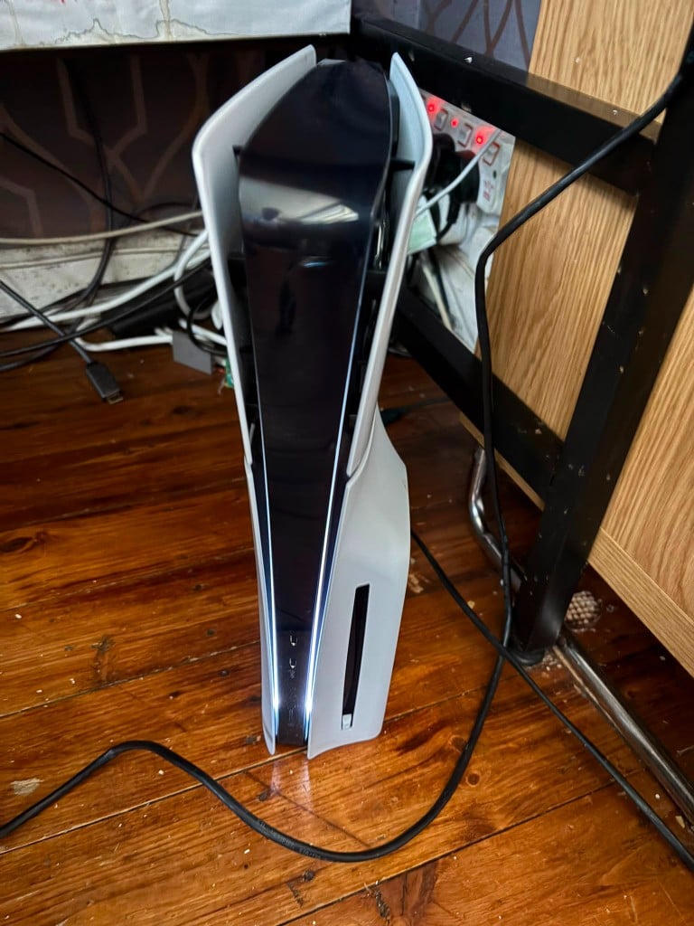 White PlayStation 5 powered on with LED strips glowing